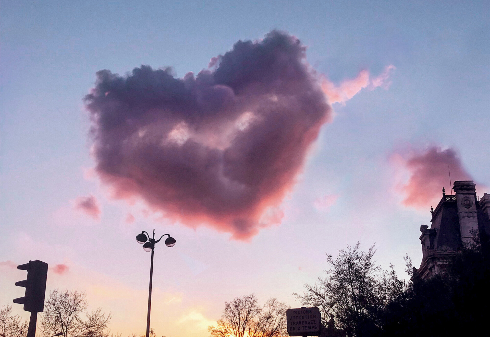 Un photographe capture un nuage rose en forme de cœur dans le ciel de Paris